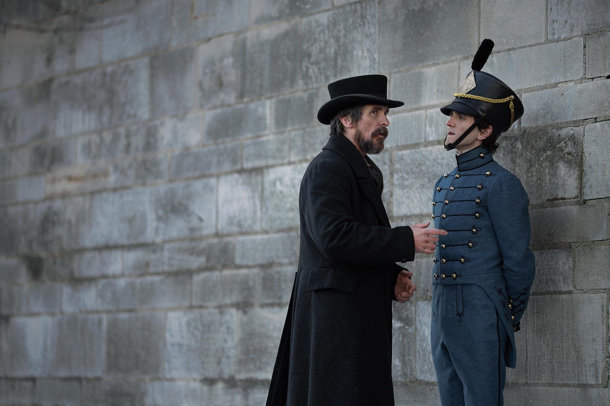 (L to R) Christian Bale as Augustus Landor and Harry Melling as Edgar Allen Poe in The Pale Blue Eye.